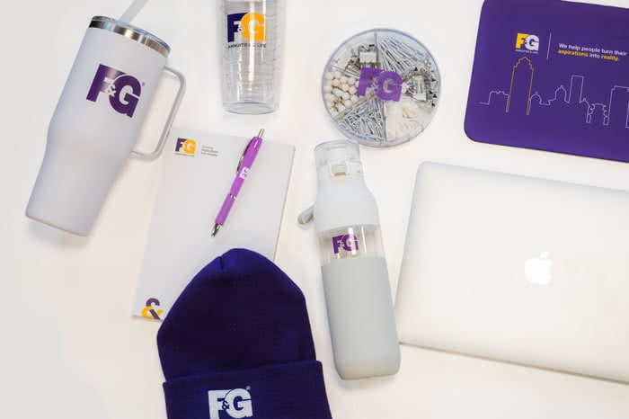 several F&G branded products including stationery, cups, and a beanie hat